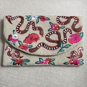 Embroidered snake and floral pattern clutch with strap. Never worn.
